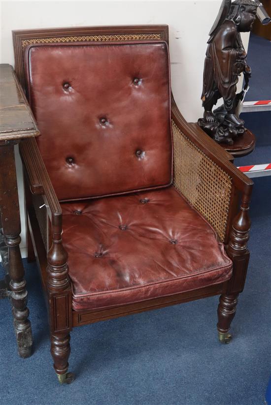 A George III mahogany Bergere with leather squab